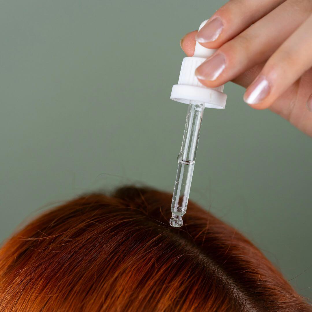 How to Use a Hair Serum Applicator for scalp health with glass dropper above hair.